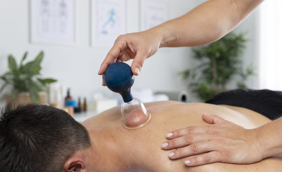 physiotherapist-performing-cupping-session-male-patient